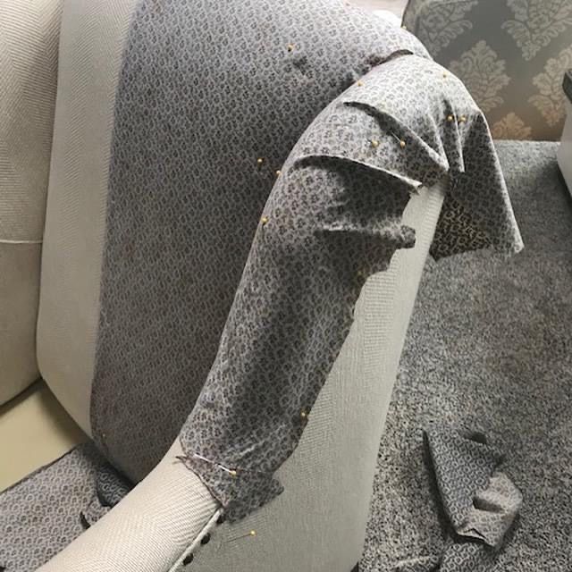 Fabric pinned to a chair arm to shape the pattern