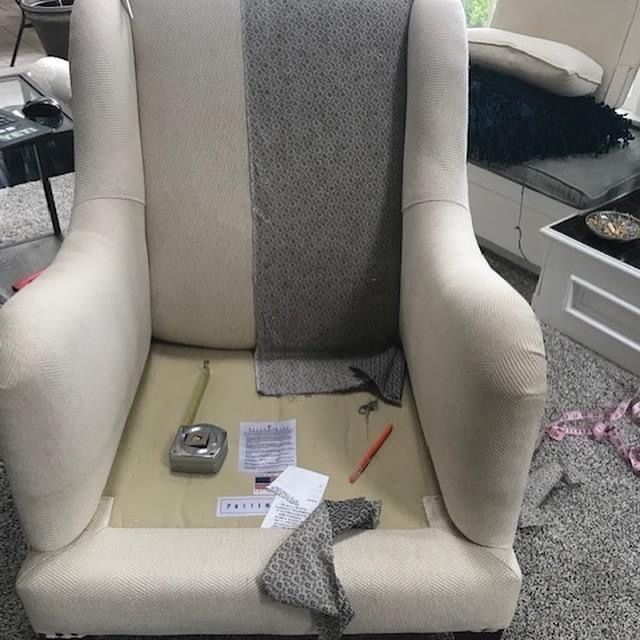 Chair stripped back with pattern pieces pinned during cover making