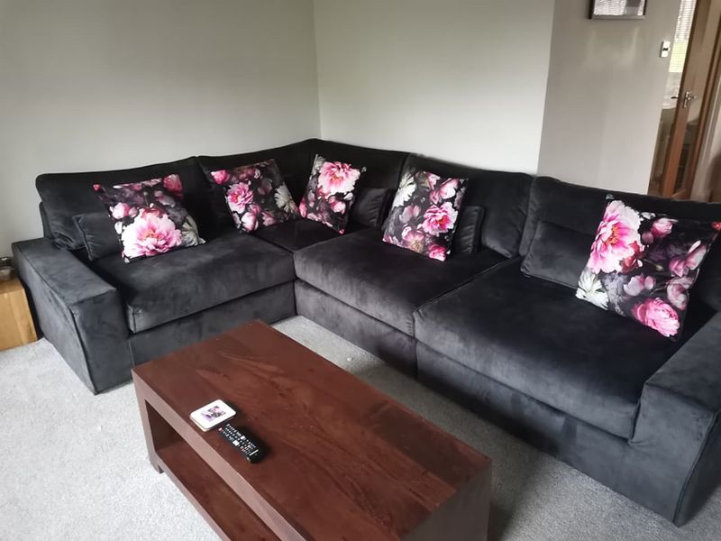 Charcoal velvet corner sofa covers with floral cushions