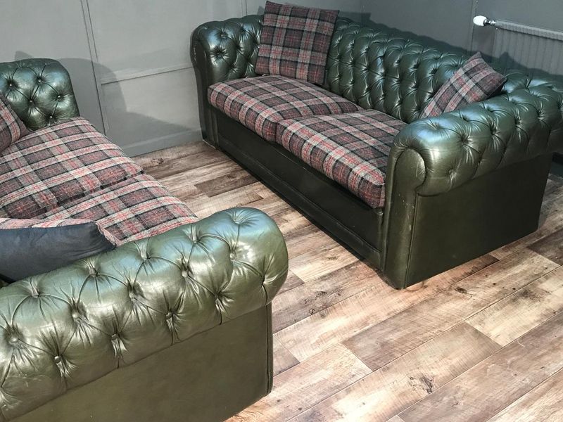 Green leather Chesterfield sofas with new tartan seat cushion covers