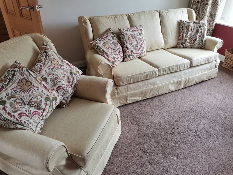 Cream linen loose covers on a sofa and armchair made by Sarah
