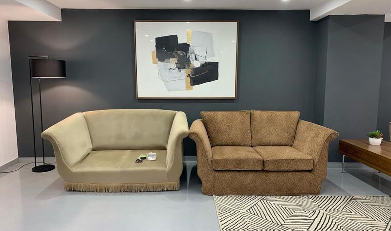 Two traditional sofas in cream and tan made-to-measure covers