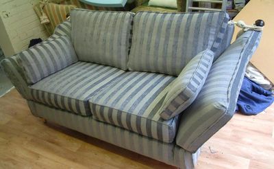 Drop-arm sofa with a striped blue and grey loose cover