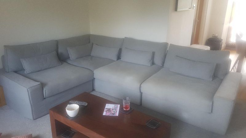 Grey corner sofa with new loose covers