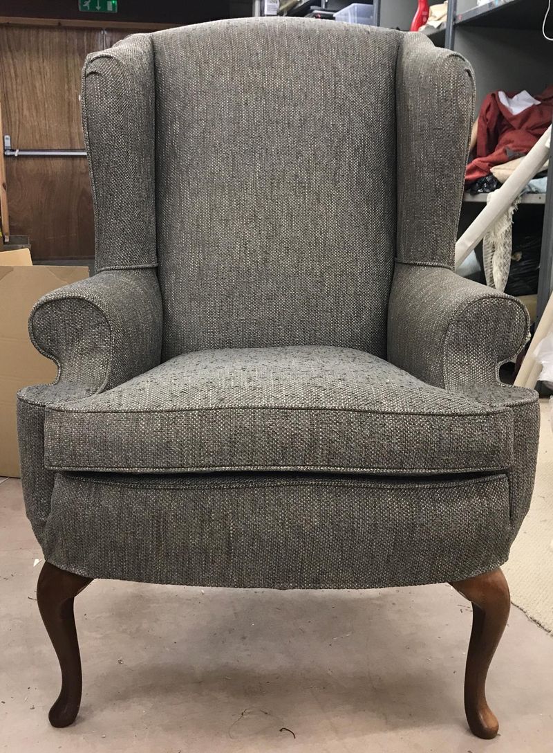Wingback chair in a tailored grey loose cover