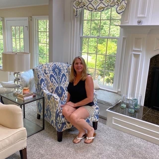 Julie sitting in her finished ikat club chair cover