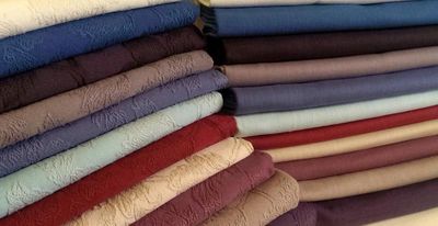 Folded loose cover fabrics in a range of colours