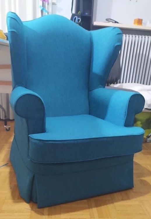 Wingback chair in a turquoise tailored loose cover made by Marlena