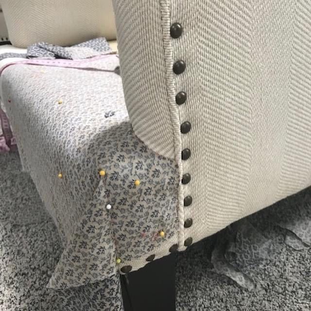 Pinned cover pieces beside a studded chair arm