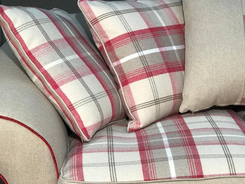 Close-up of check cushions on a Tetrad Alicia sofa cover with red piping