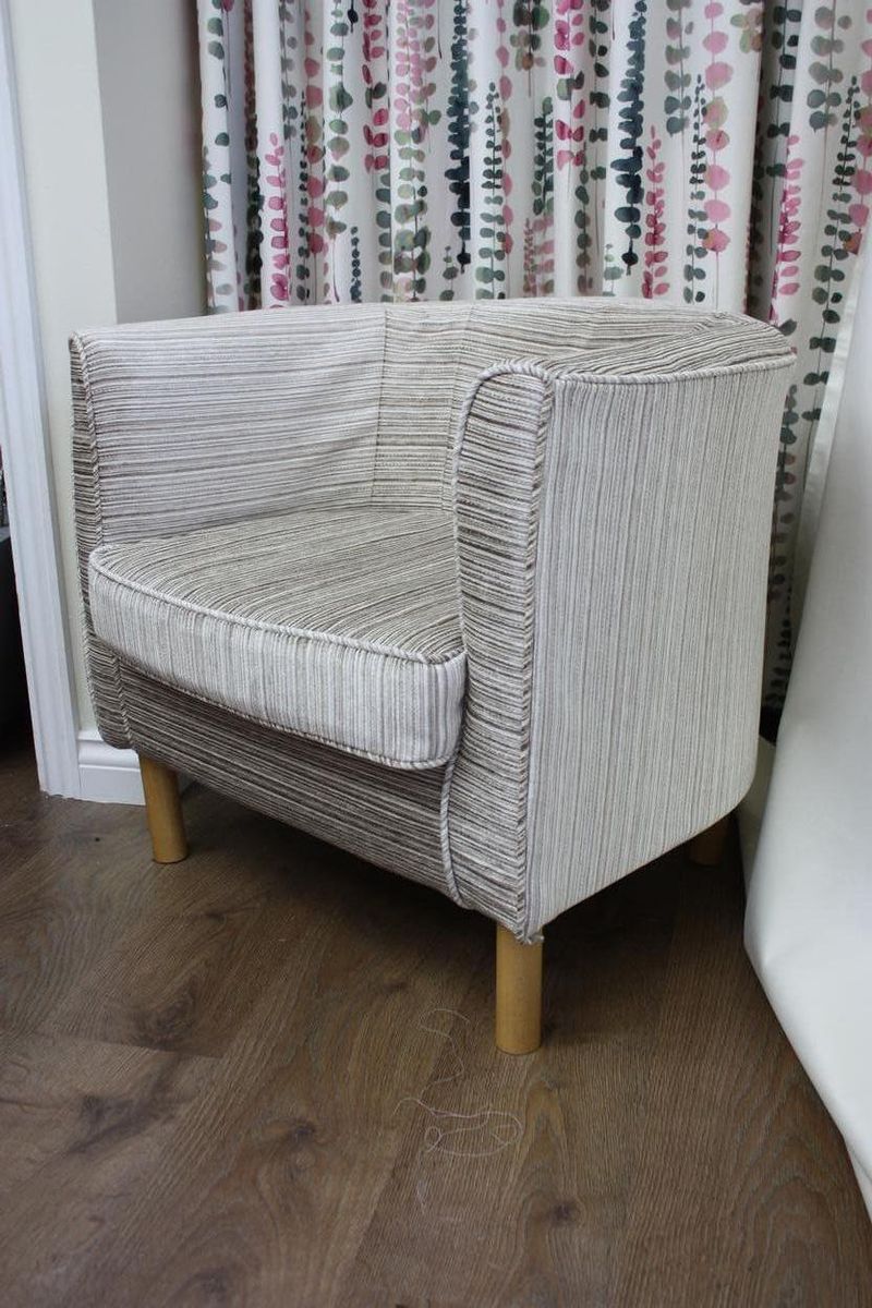 Tub chair with a striped loose cover