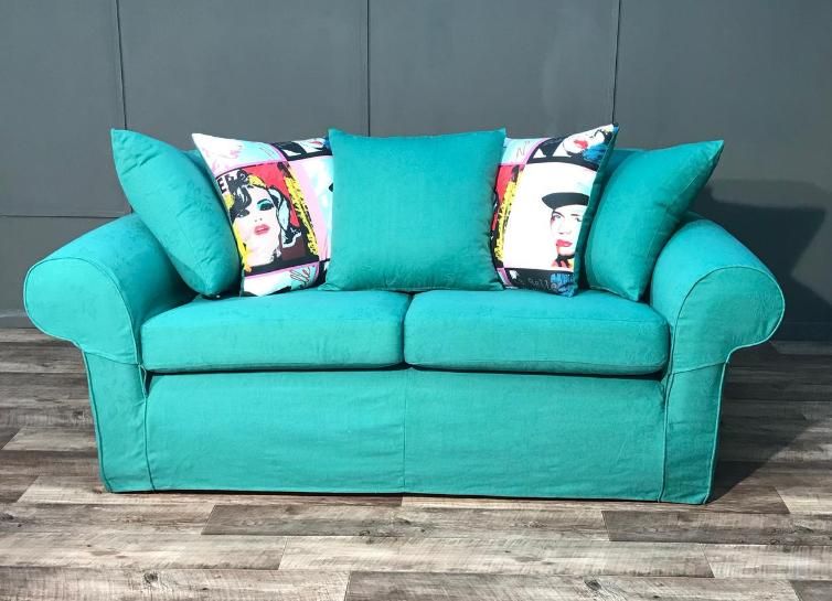 Turquoise sofa loose cover with pop-art cushions