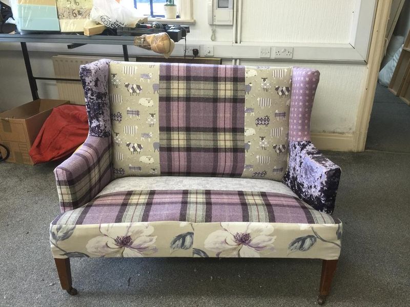 Wing chair in a lilac tartan and floral patchwork loose cover