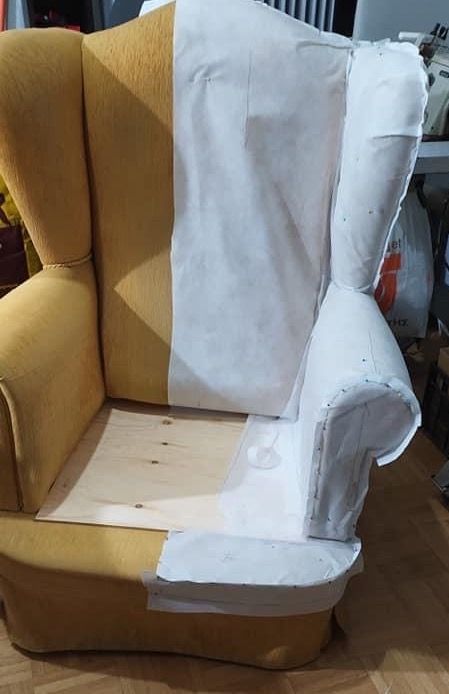 Calico pattern pinned on a mustard wingback chair