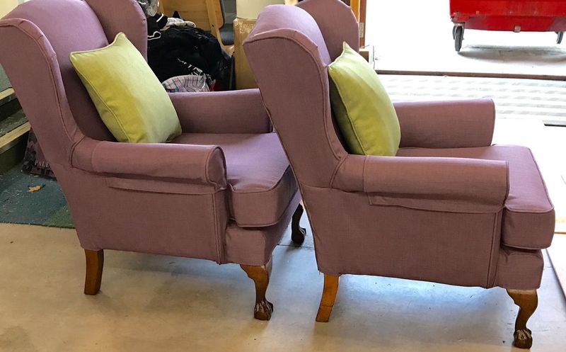 Pair of wingback chairs in mauve loose covers with lime cushions